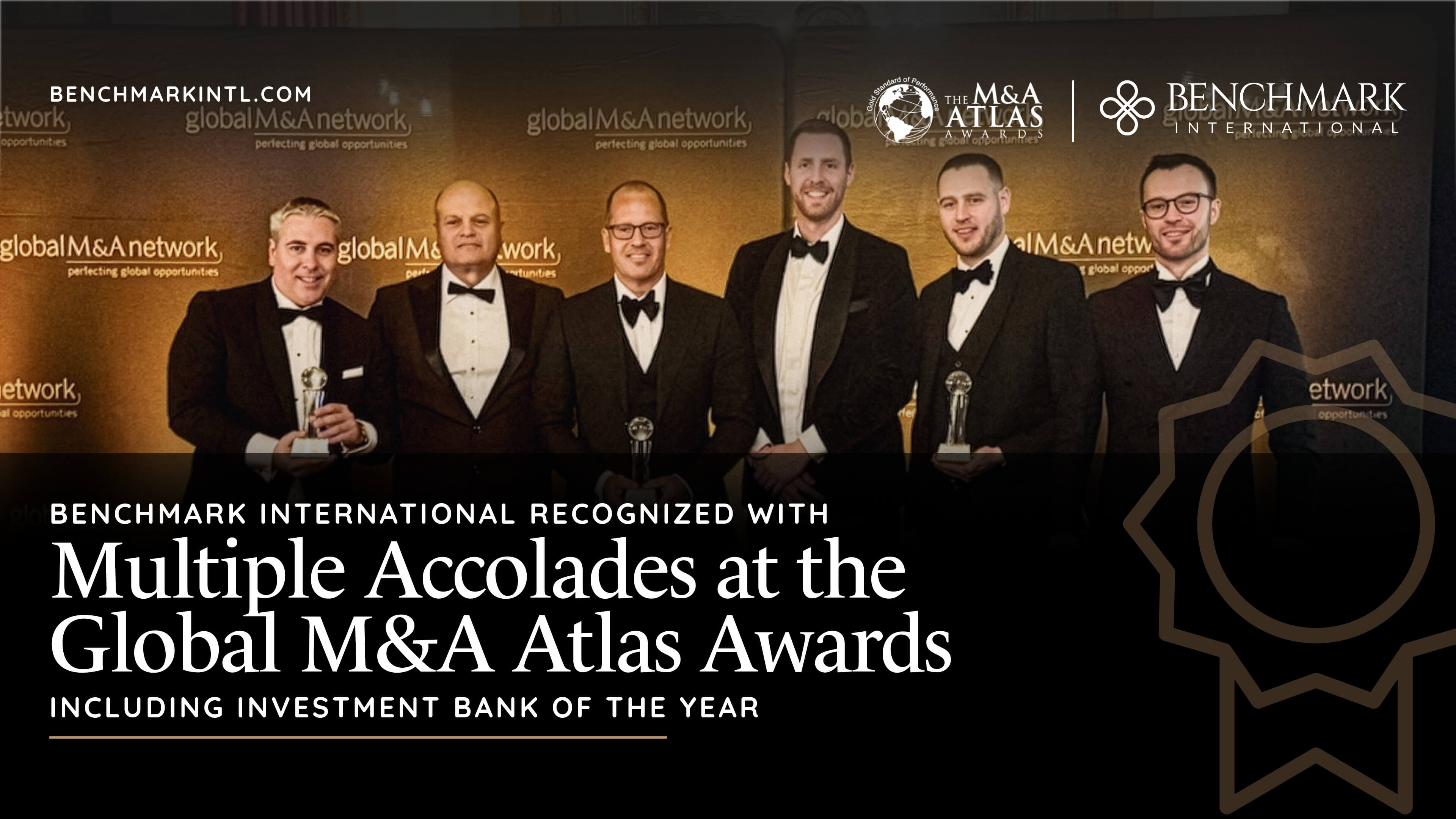 "Benchmark International recognized with multiple accolades at the global m&a atlas awards including Investment Bank of the year " is written over an image our Benchmark International's team accepting the award at the ceremony.